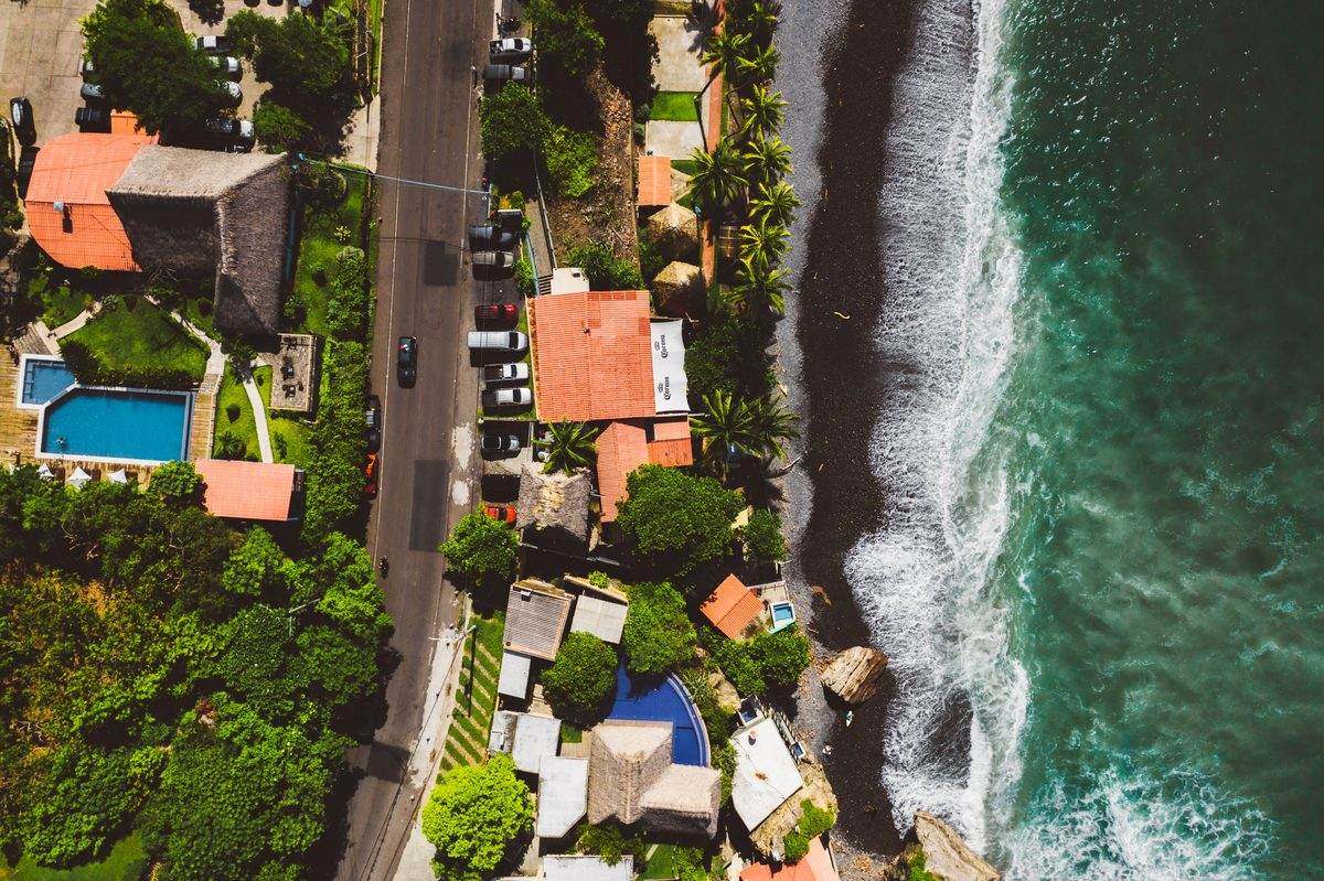Drone view straight down on La Ola, the cobblestone beach and the wave peeling along it